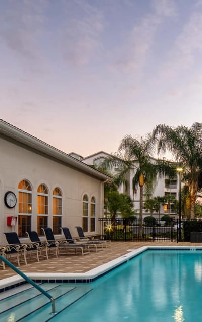 Resort-style swimming pool with lounge chairs
