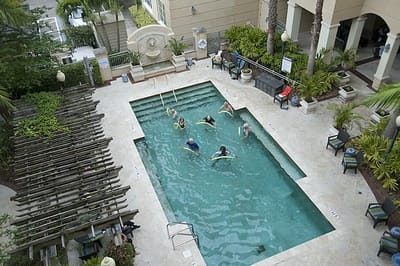 Residents enjoying water exercises in the pool area