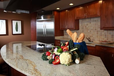 A beautifully arranged assortment of fresh vegetables and bread in a kitchen