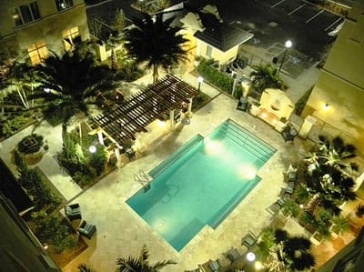 Aerial view of a serene outdoor pool area with palm trees