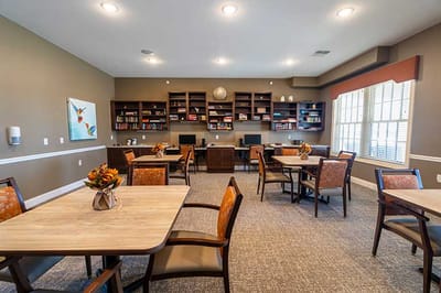 Bright common area with tables and bookshelves