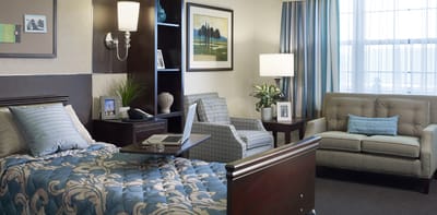 Well-furnished private resident room with seating area