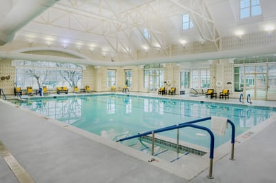 Indoor swimming pool area with lounge chairs