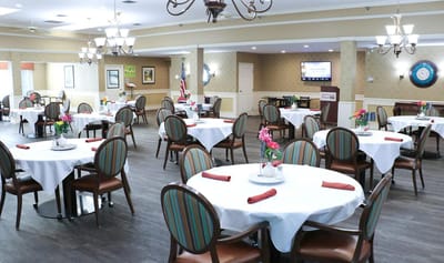 Dining room set for meals with flowers on tables