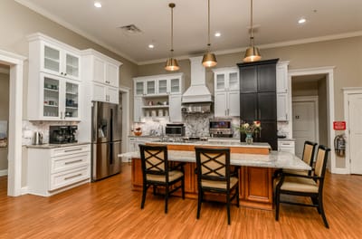 Modern kitchen area with stylish appliances and seating