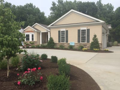 Exterior view of a senior living facility with landscaped garden