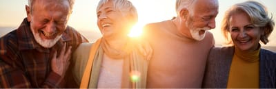 Seniors laughing together during a sunset