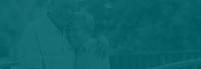 Elderly couple smiling together in a teal overlay