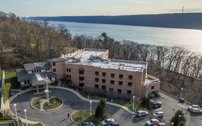 Aerial view of a senior living facility by the river