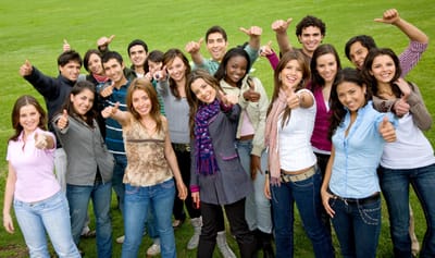 Group of young adults giving thumbs up outside
