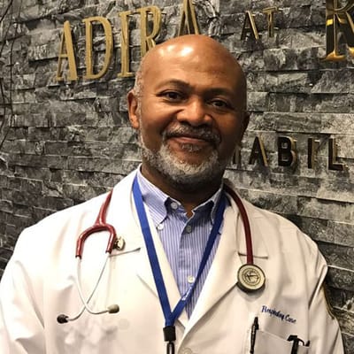 A doctor in a medical facility with a friendly smile