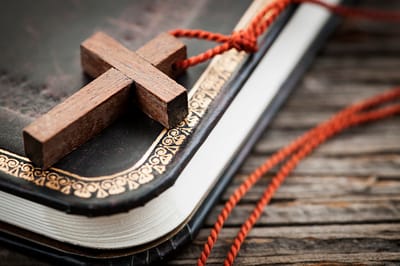 Close-up of a wooden cross on a book