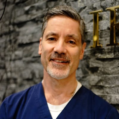 A male staff member smiling in a care facility
