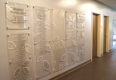 Recognition wall featuring donor names and leaves design
