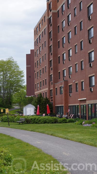 Exterior view of a senior living facility with green space