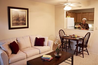 Cozy living space with an older adult cooking