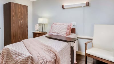Cozy resident room with bed and chair