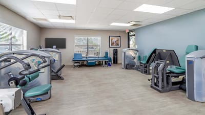 Interior exercise room with various workout machines