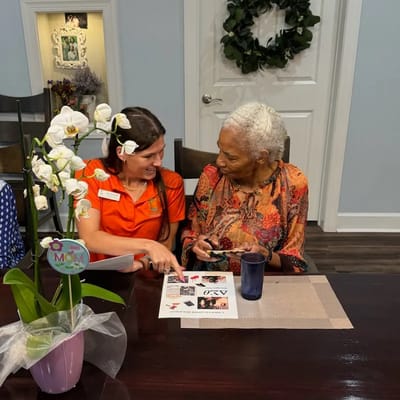 Staff member engaging with a resident in a common area.