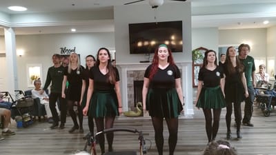 Residents and staff participating in a dance performance