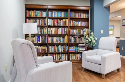 Cozy reading area with bookshelves and chairs