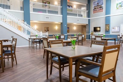 Spacious common area with tables and chairs.