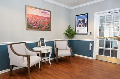 Welcoming seating area with floral artwork and decor.