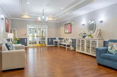Bright common area with seating and decor.