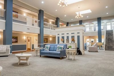 Common area with seating and stairway in a nursing home.