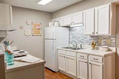 Modern kitchen interior with white cabinets.