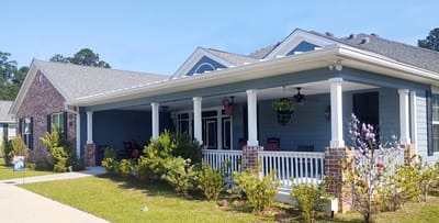 Exterior view of the facility with a porch and landscaping.