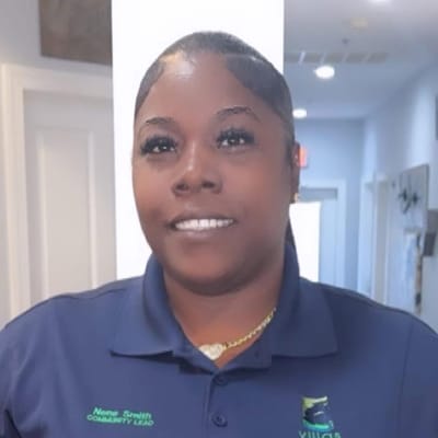 Community lead staff member smiling in facility