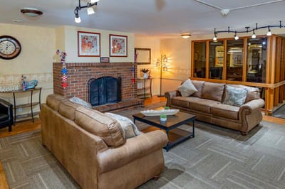 Cozy common area with sofas and a fireplace.