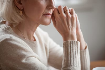 Close-up of a thoughtful senior woman's hands