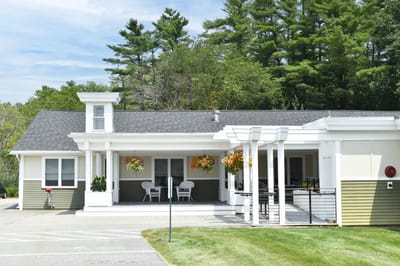 Exterior view of the facility with landscaping and seating.