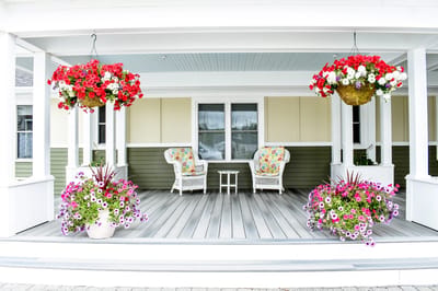 Welcoming porch with flower planters and seating