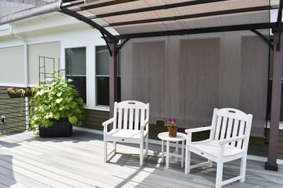 Outdoor seating area with chairs and potted plants