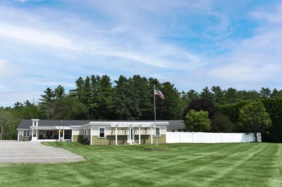 Exterior view of assisted living facility with flag.