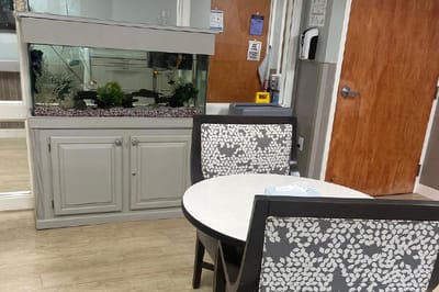 Common area with a fish tank and seating.