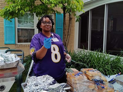 Staff member serving food outdoors