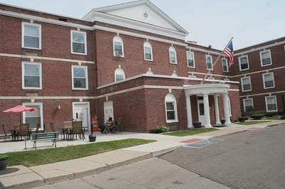Building exterior with seating area and flag