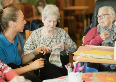 Residents and staff engaged in an activity together.