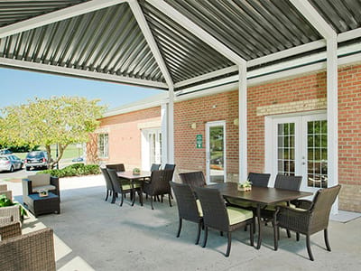 Outdoor seating area with tables and chairs.
