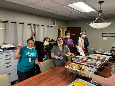Staff members serving food in a dining area
