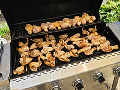 Grilling chicken wings outdoors