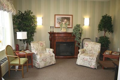Cozy seating area in facility with floral chairs.