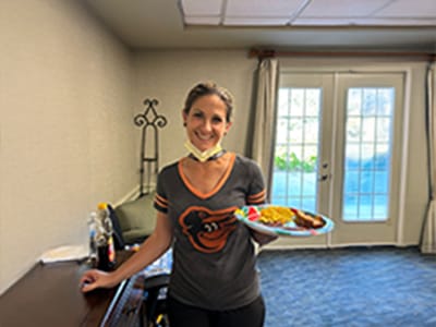 Staff member serving a meal to residents