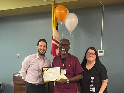 Staff presenting an award to a resident
