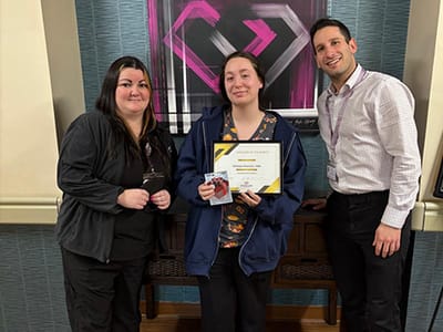 Staff and resident celebrating an achievement.