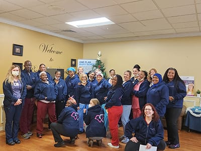 Staff members posing together in a common area.